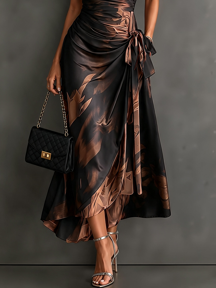 Maddie | Midi wrap dress with abstract red-black print, V-neck, short sleeves, tie belt, and asymmetrical ruffle hem