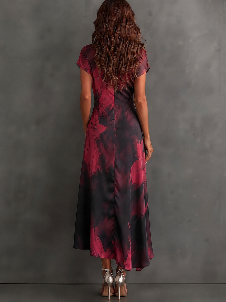 Maddie | Midi wrap dress with abstract red-black print, V-neck, short sleeves, tie belt, and asymmetrical ruffle hem