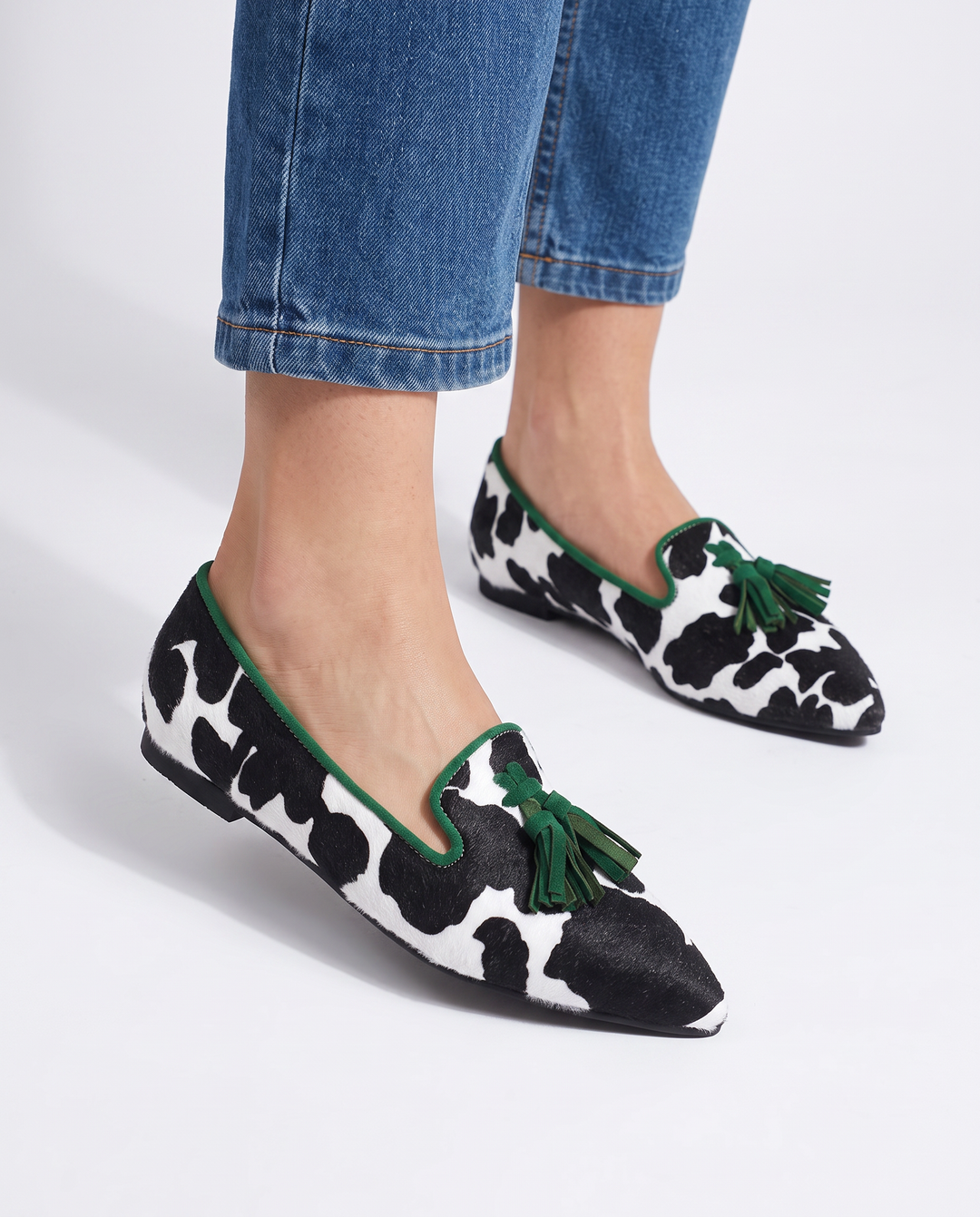 Genevieve | Moccasin Black and White Cow Print, Green Tassels