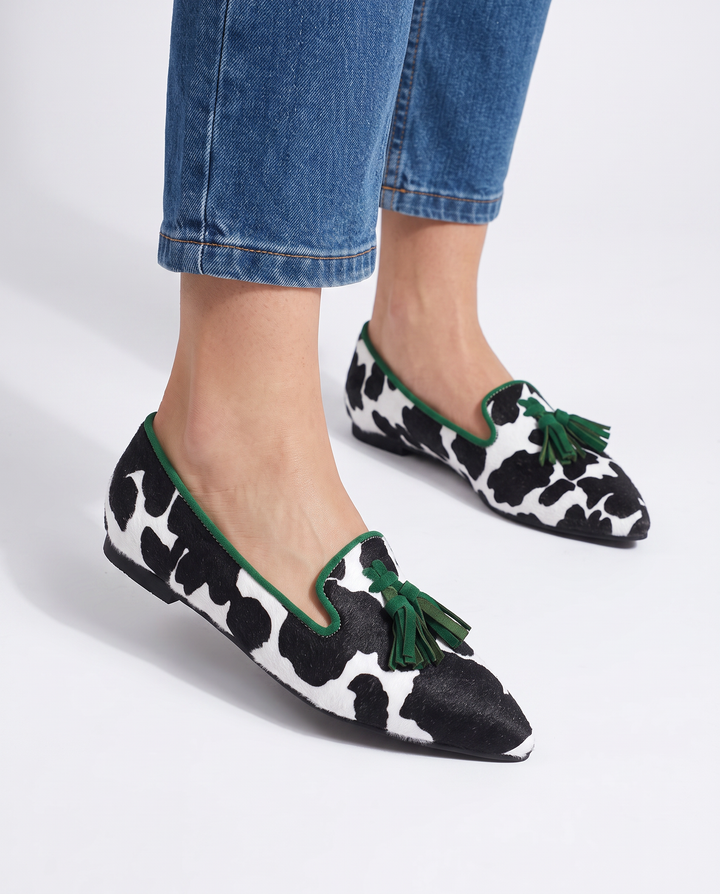 Genevieve | Moccasin Black and White Cow Print, Green Tassels