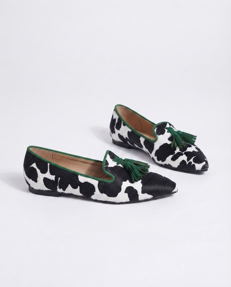 Genevieve | Moccasin Black and White Cow Print, Green Tassels